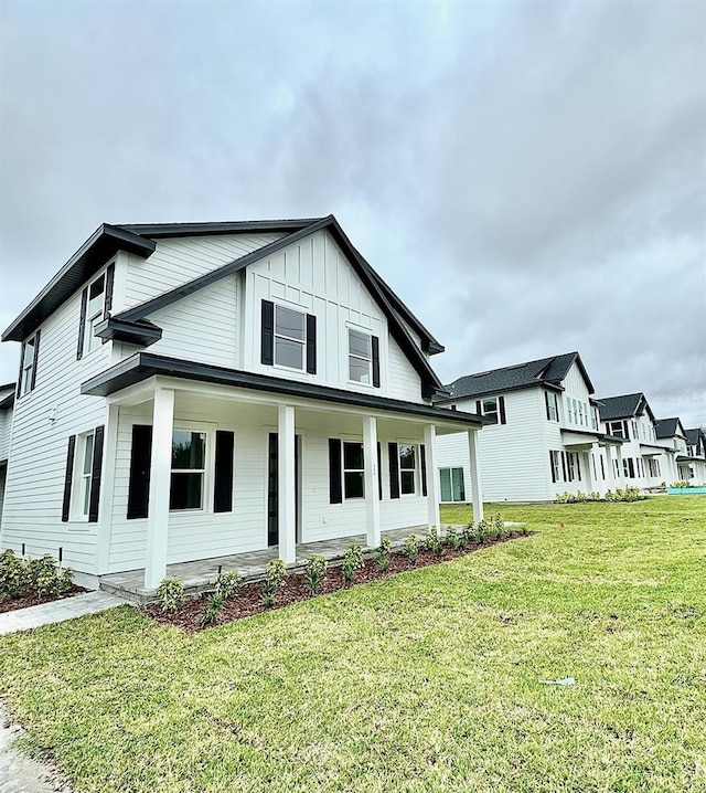 view of front of house with a front lawn and covered porch