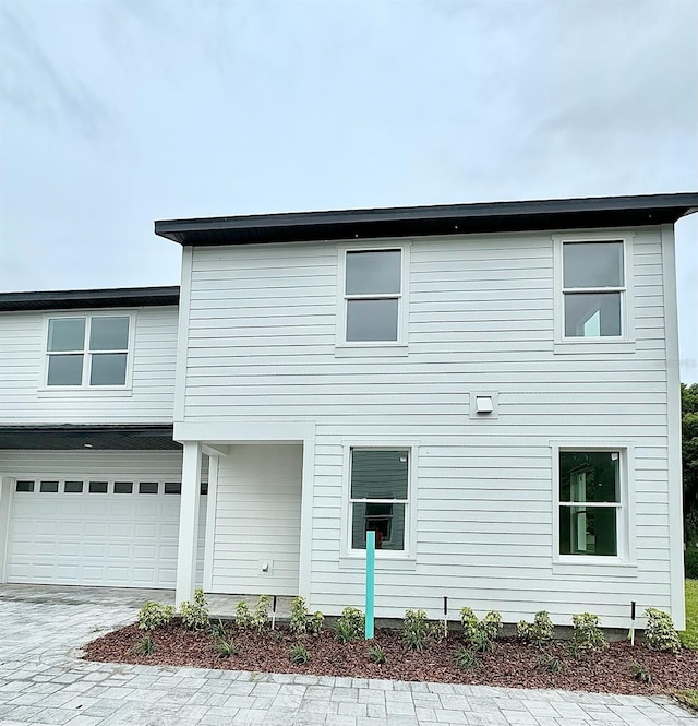 view of side of home featuring a garage