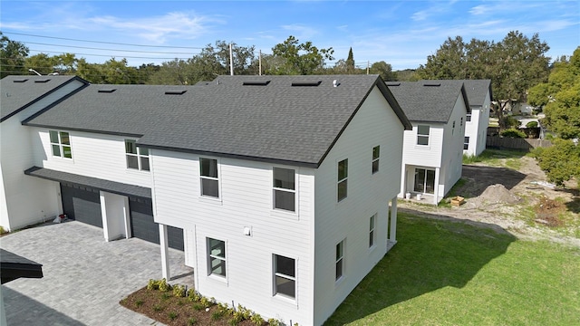 exterior space with a yard and a garage