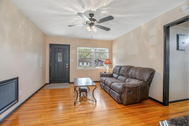 living room with light hardwood / wood-style floors and ceiling fan