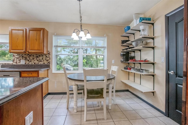 dining area with a notable chandelier and light tile patterned flooring