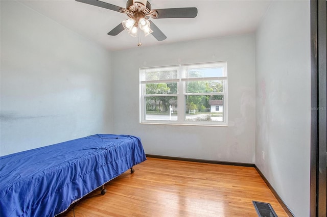 bedroom with light hardwood / wood-style flooring and ceiling fan