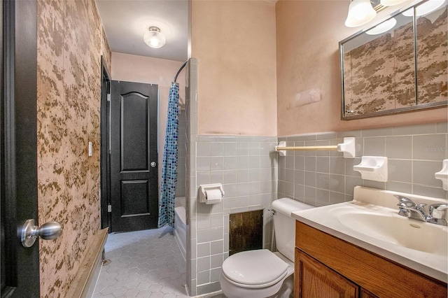 full bathroom with tile walls, toilet, shower / bath combo, vanity, and tile patterned floors