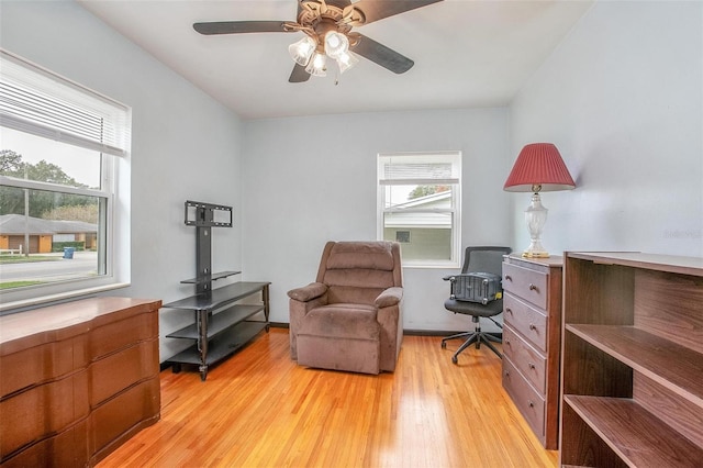 living area with ceiling fan and light wood-type flooring