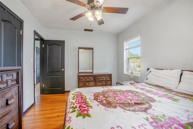 bedroom with ceiling fan and light wood-type flooring