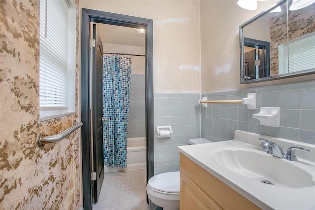 full bathroom featuring vanity, toilet, shower / bathtub combination with curtain, and tile walls