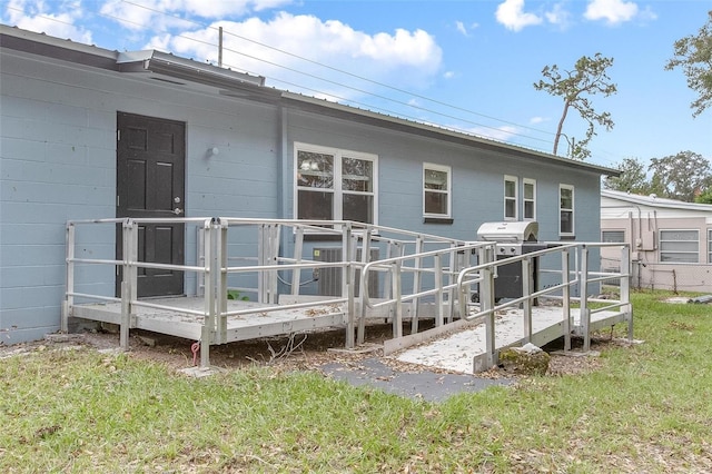 rear view of house with a wooden deck, a yard, and central air condition unit