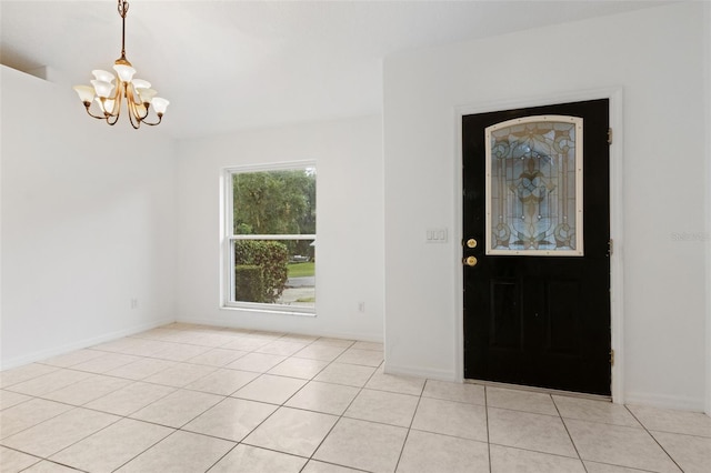 tiled entryway with an inviting chandelier