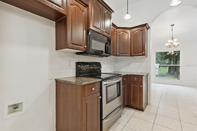 kitchen featuring dark stone counters, decorative backsplash, electric stove, and an inviting chandelier