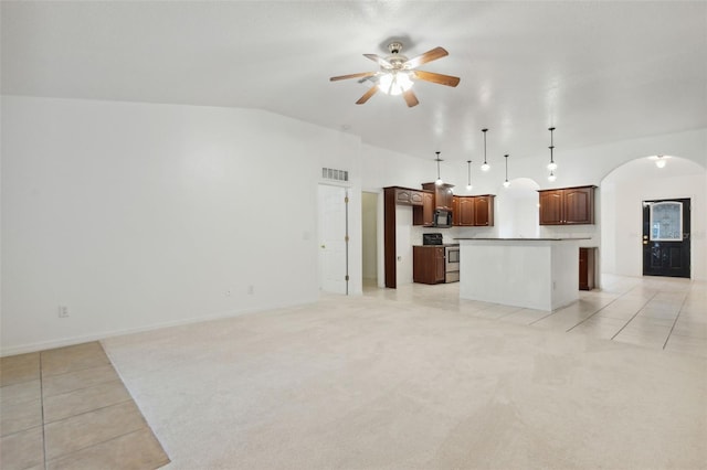 kitchen featuring ceiling fan, a kitchen island, electric range, hanging light fixtures, and light tile patterned floors