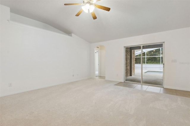 empty room with light carpet, vaulted ceiling, and ceiling fan