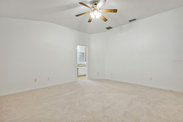 unfurnished room featuring lofted ceiling, light colored carpet, and ceiling fan