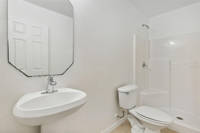 bathroom featuring sink, toilet, and walk in shower