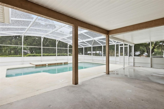 view of swimming pool featuring a patio and glass enclosure