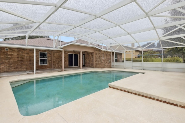 view of swimming pool featuring a lanai and a patio