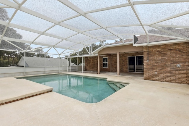 view of swimming pool featuring a patio and a lanai