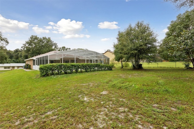 view of yard with glass enclosure