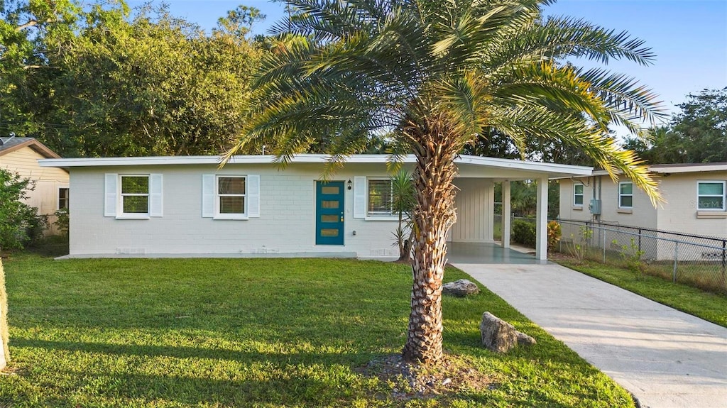 ranch-style house with a carport and a front yard