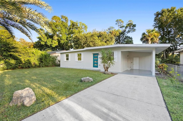 ranch-style house featuring a carport and a front yard