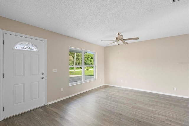 entrance foyer featuring dark hardwood / wood-style flooring, a textured ceiling, and ceiling fan