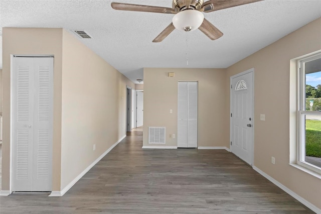 entryway featuring wood-type flooring, ceiling fan, and a textured ceiling