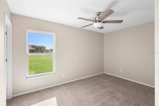 carpeted spare room with ceiling fan and a textured ceiling