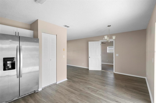 kitchen with white cabinets, hardwood / wood-style flooring, a chandelier, decorative light fixtures, and stainless steel refrigerator with ice dispenser