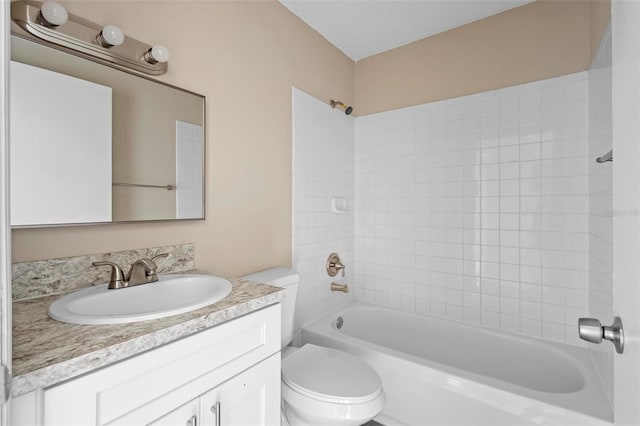 full bathroom featuring vanity, toilet, and tiled shower / bath