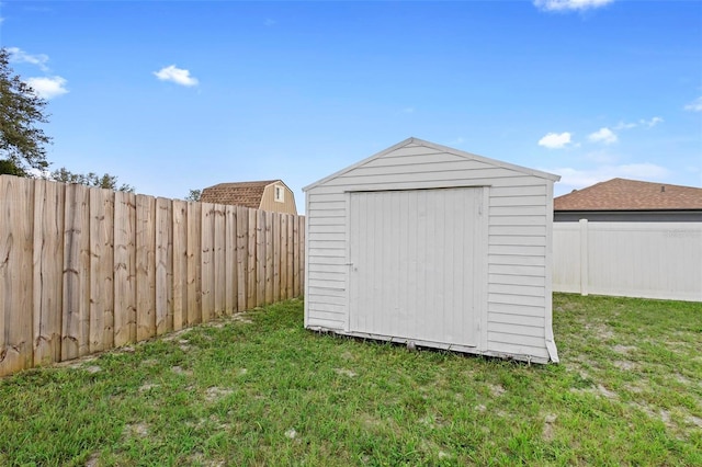 view of outbuilding with a yard