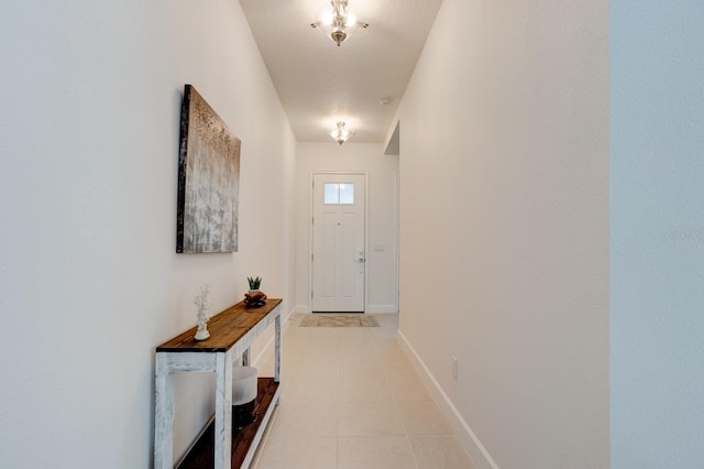 doorway to outside with light tile patterned floors