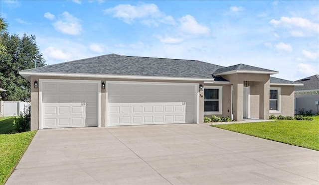 view of front facade with a garage and a front lawn