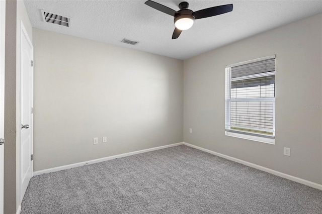 spare room with carpet, a textured ceiling, and ceiling fan