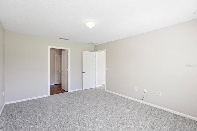 unfurnished bedroom with dark colored carpet