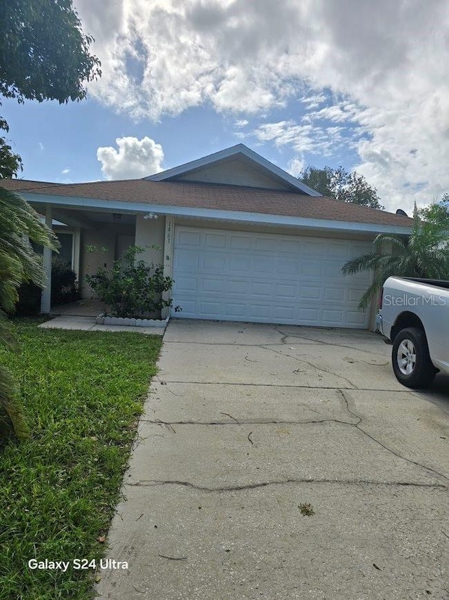 1461 N Felton St, Deltona, FL 32725 - ranch-style house with a garage, concrete driveway, and stucco siding