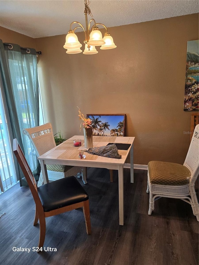 dining area with a notable chandelier and dark hardwood / wood-style flooring