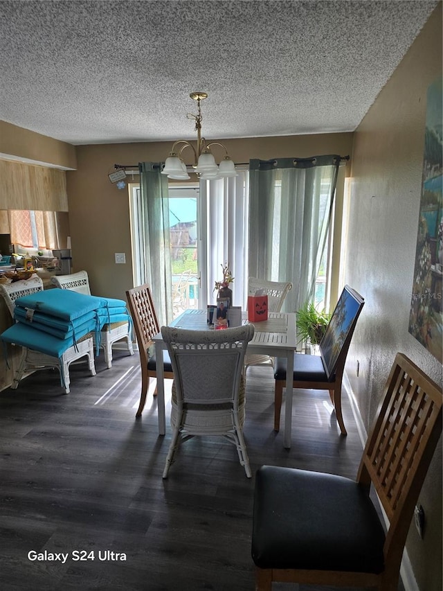 dining area featuring a notable chandelier, a textured ceiling, and hardwood / wood-style flooring