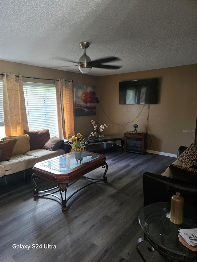 living room featuring a textured ceiling, wood-type flooring, and ceiling fan