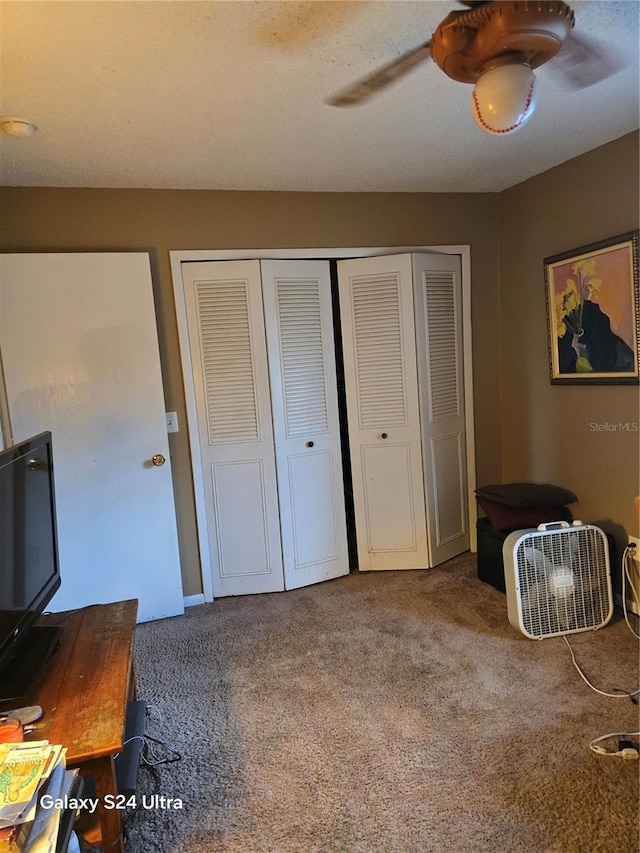 carpeted bedroom featuring a closet and ceiling fan