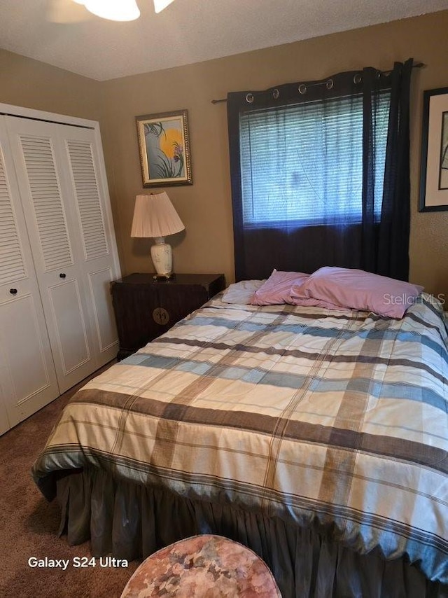 bedroom with carpet floors, a closet, and ceiling fan