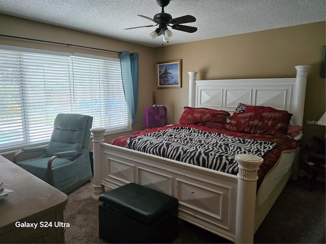 bedroom with dark carpet, a textured ceiling, and ceiling fan