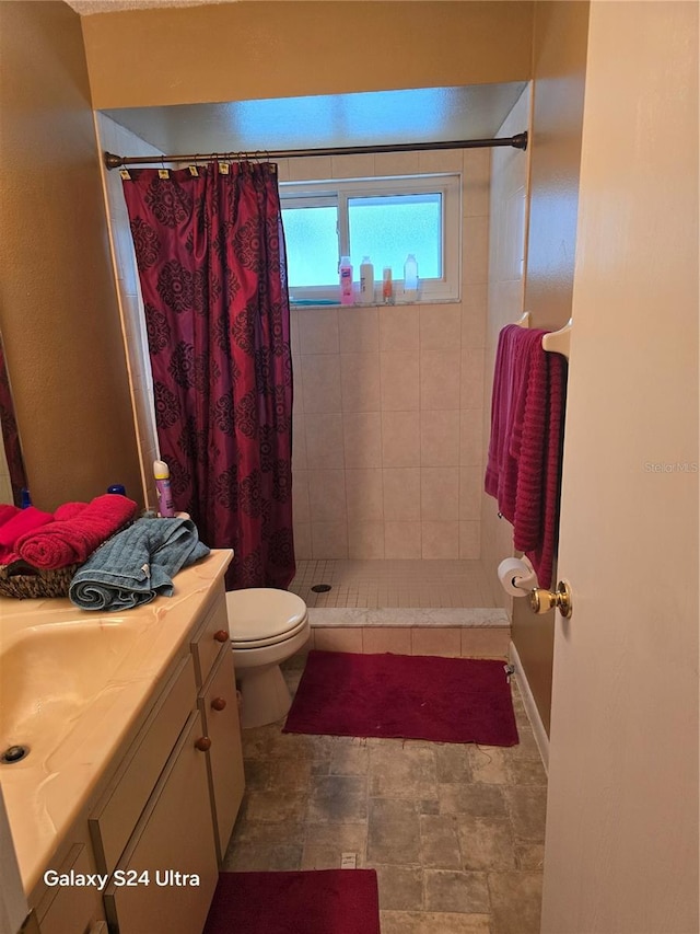 bathroom featuring vanity, toilet, and a shower with shower curtain