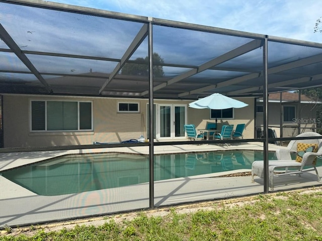 view of pool featuring a patio and glass enclosure