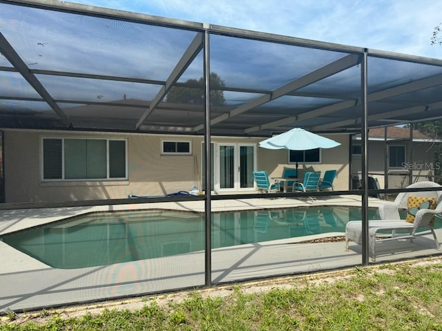 1461 N Felton St, Deltona, FL 32725 - swimming pool featuring french doors, a patio area, and glass enclosure