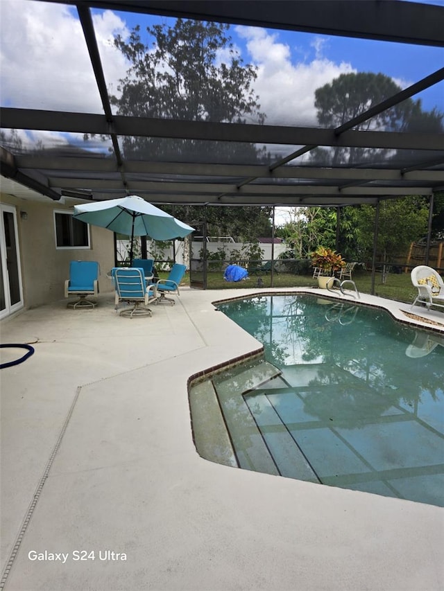 view of pool featuring a patio and glass enclosure