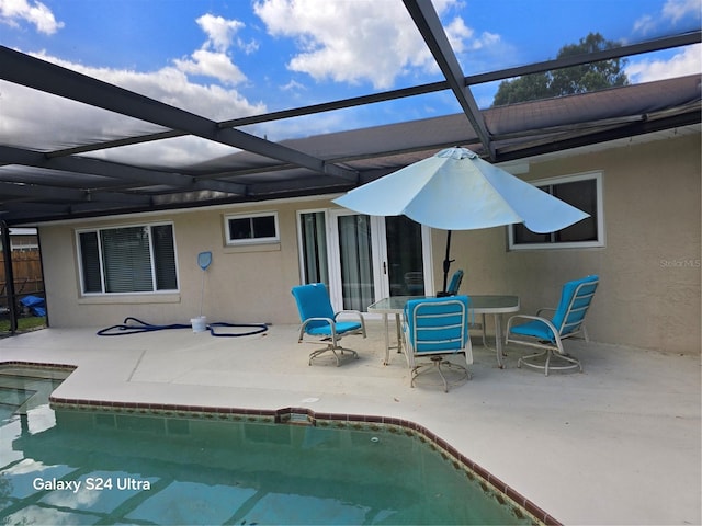 1461 N Felton St, Deltona, FL 32725 - rear view of house with stucco siding, a patio, an outdoor pool, and glass enclosure