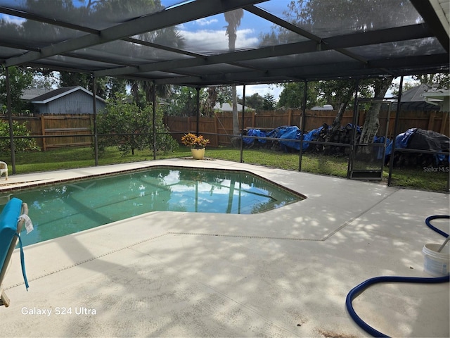 view of pool featuring a patio area and glass enclosure