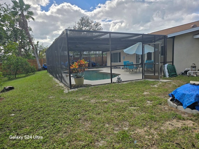 1461 N Felton St, Deltona, FL 32725 - back of property with a patio, stucco siding, and glass enclosure