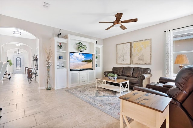 tiled living room with ceiling fan