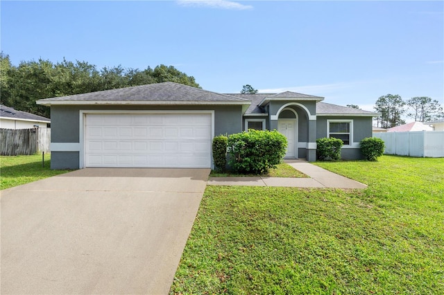 ranch-style house featuring a front lawn and a garage