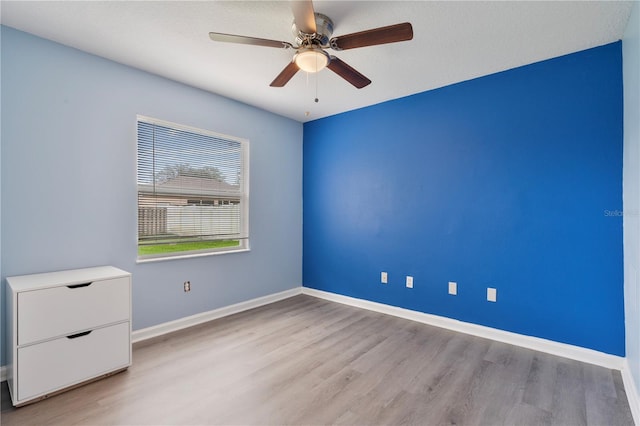 unfurnished room with ceiling fan and light hardwood / wood-style floors